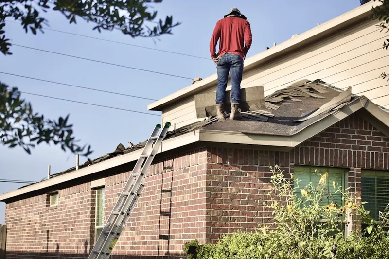 Professional roofer working on a residential roof in Rolling Fields